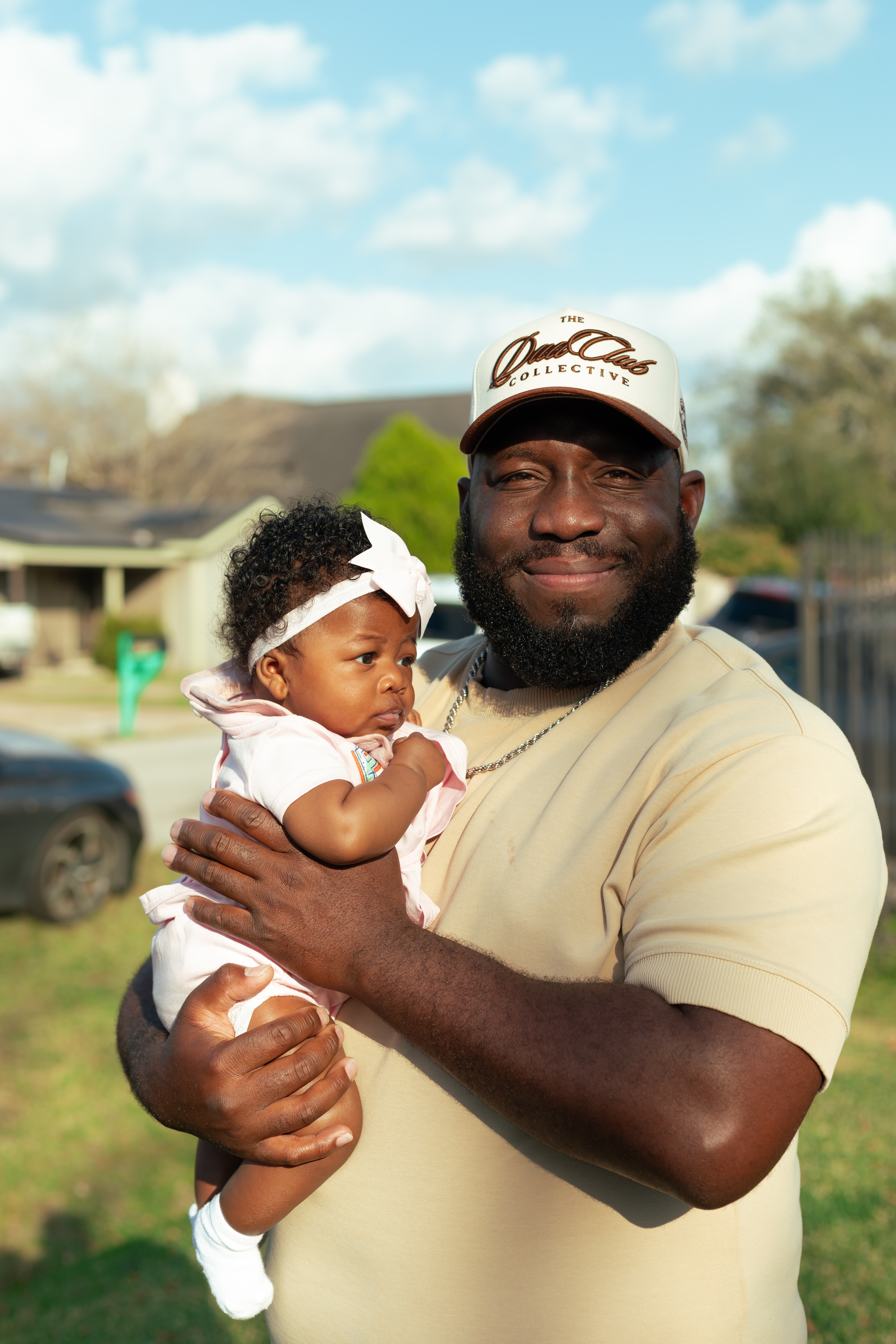 Portrait of a couple embracing during an outdoor gathering at sunset.